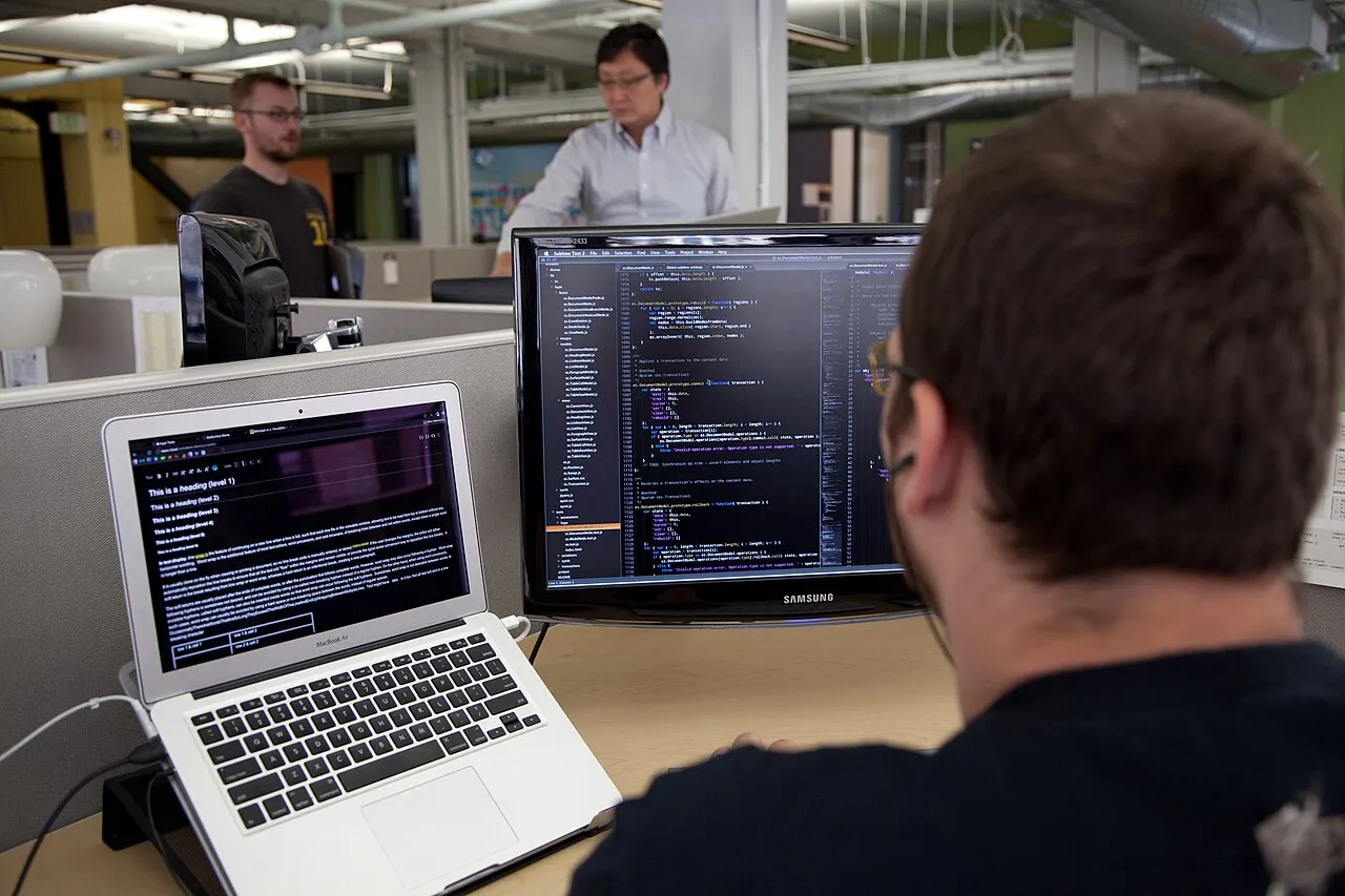 A programmer writing code on a computer screen